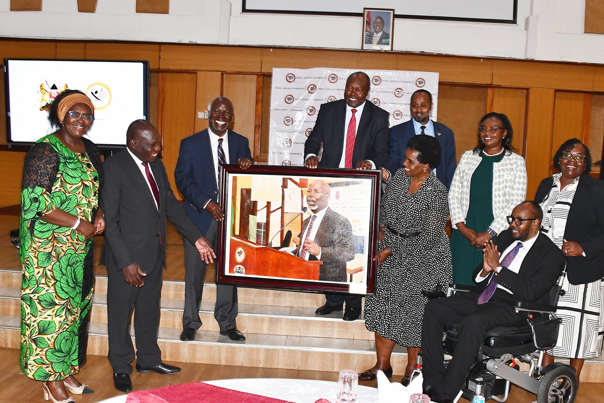 PSC commissioners handing over signature gift to Muchiri